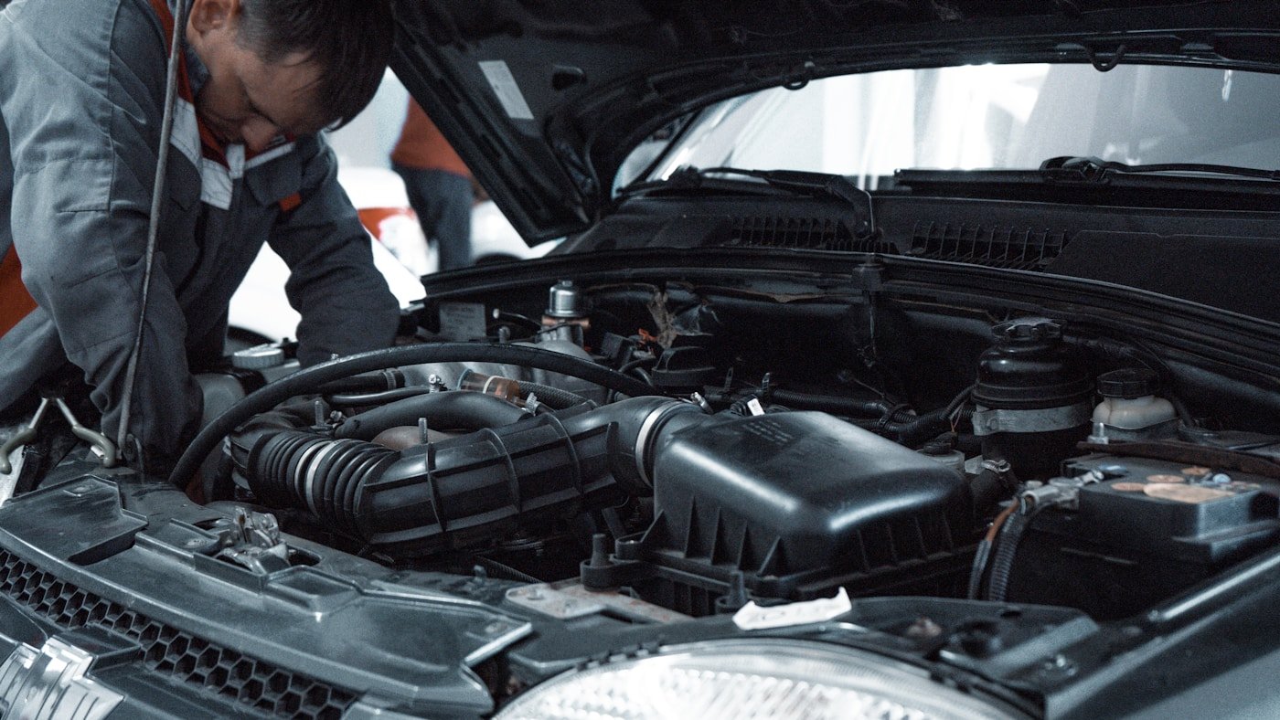 Automotive Lab mechanic inspecting a car engine in Clyde North